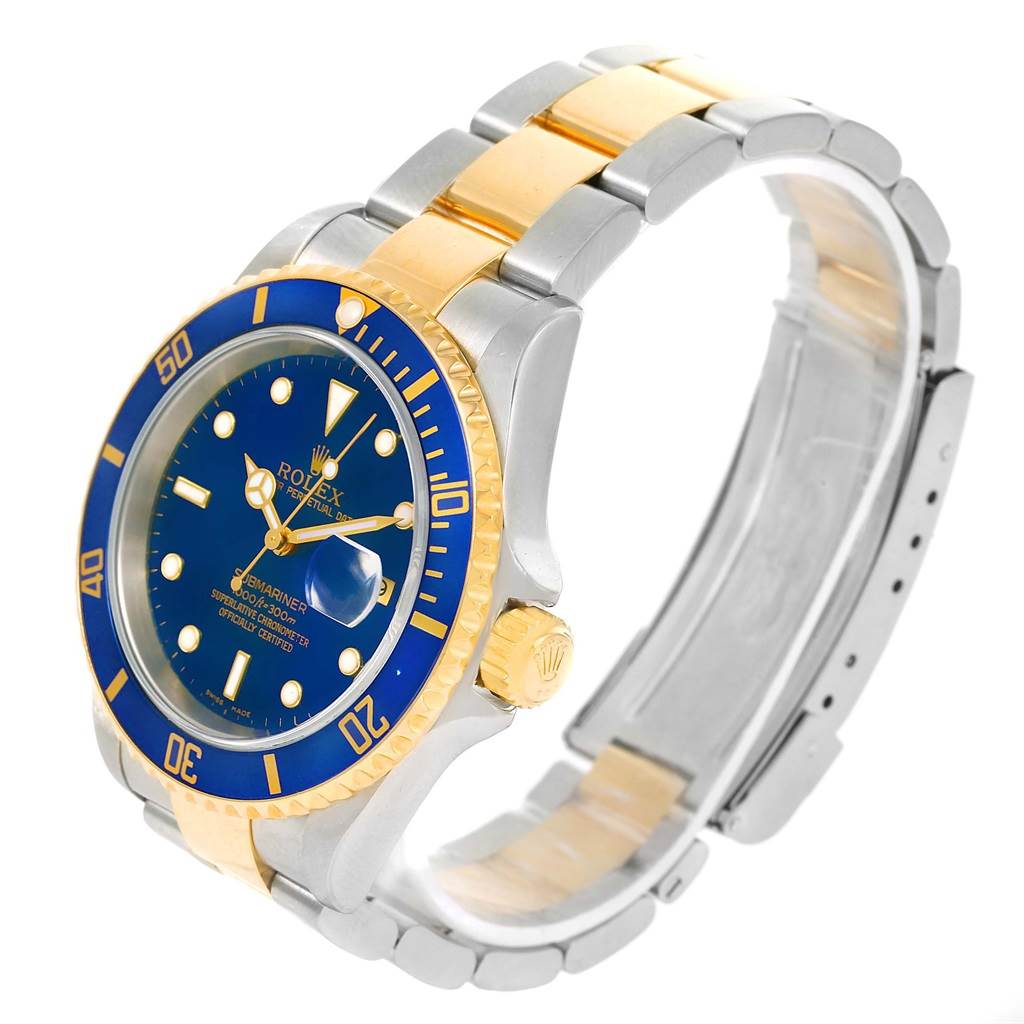 The Rolex Submariner 16613 Men
s Steel and Gold (two tone) Blue Dial 16613 Men
s Steel and Gold (two tone) Blue Dial watch is shown from an angled side view, displaying its blue dial, bezel, and two-tone metal bracelet.