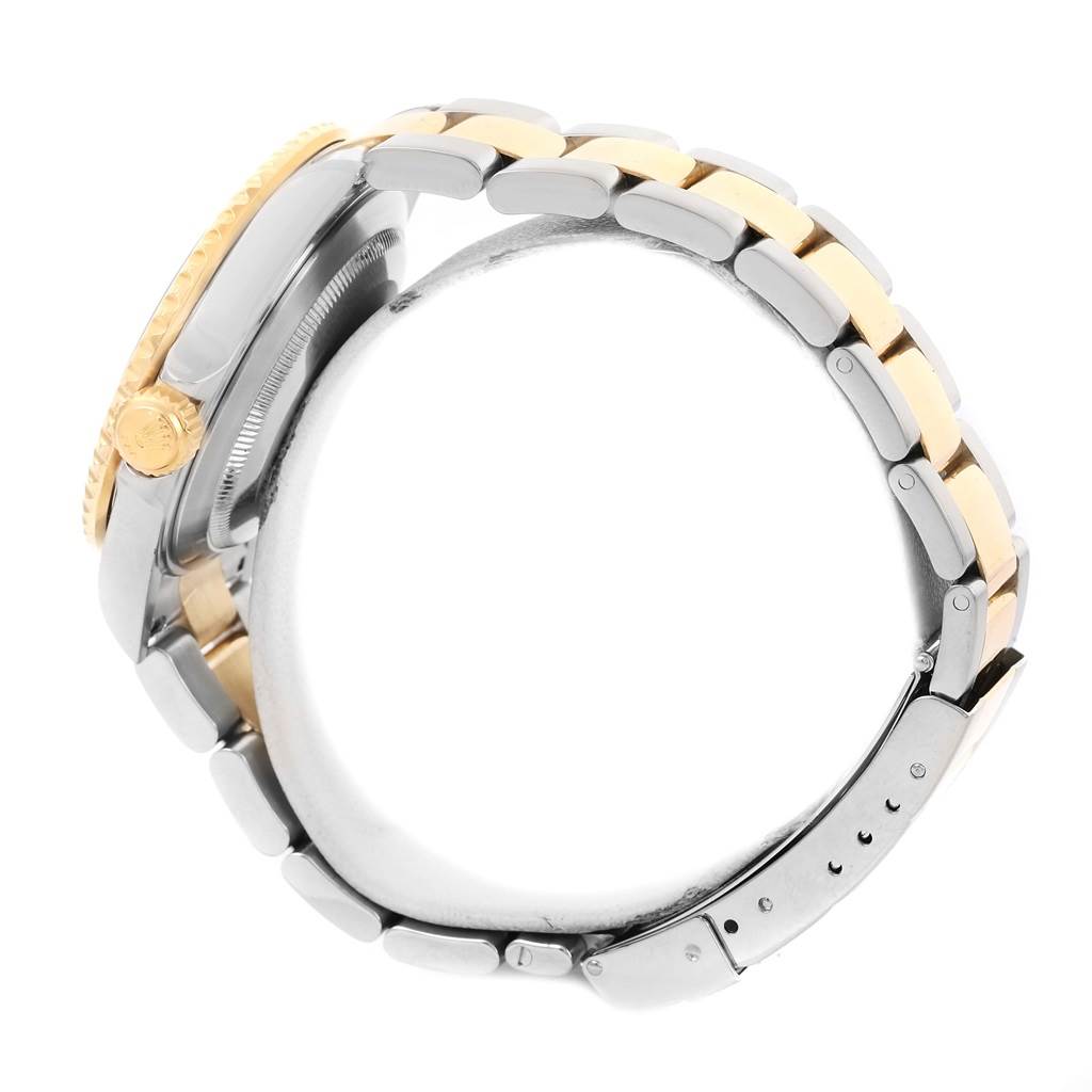 The image shows a side view of the case, crown, and bracelet of a Rolex Submariner 16613 Men
s Steel and Gold (two tone) Blue Dial 16613 Men
s Steel and Gold (two tone) Blue Dial watch.