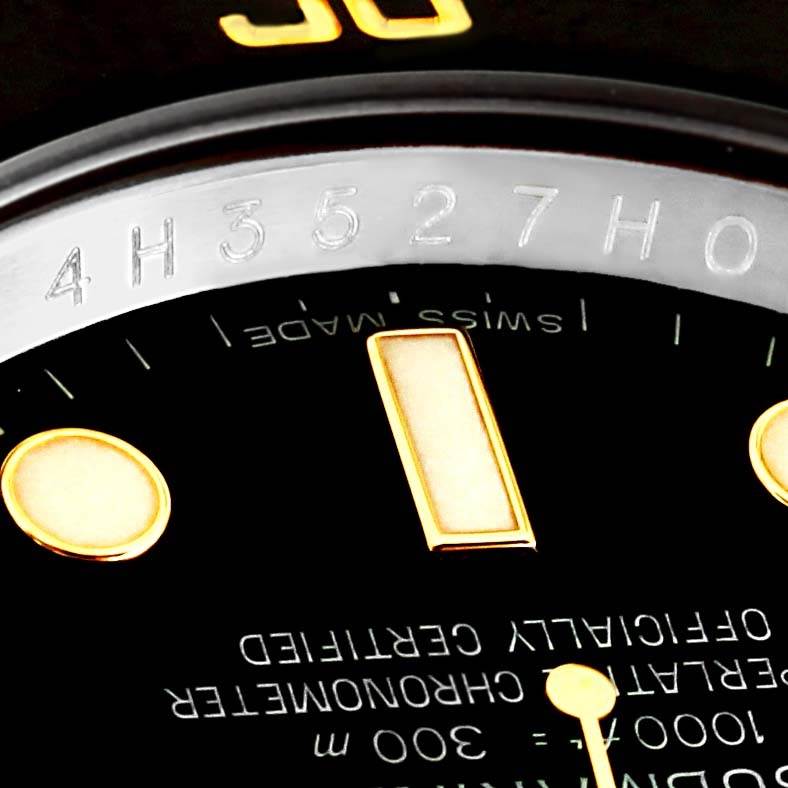 The image shows a close-up of the dial and bezel of a Rolex Submariner 116613LN Men
s Steel and Gold (two tone) Black Dial 116613LN Men
s Steel and Gold (two tone) Black Dial watch, highlighting the serial number and part of the face.