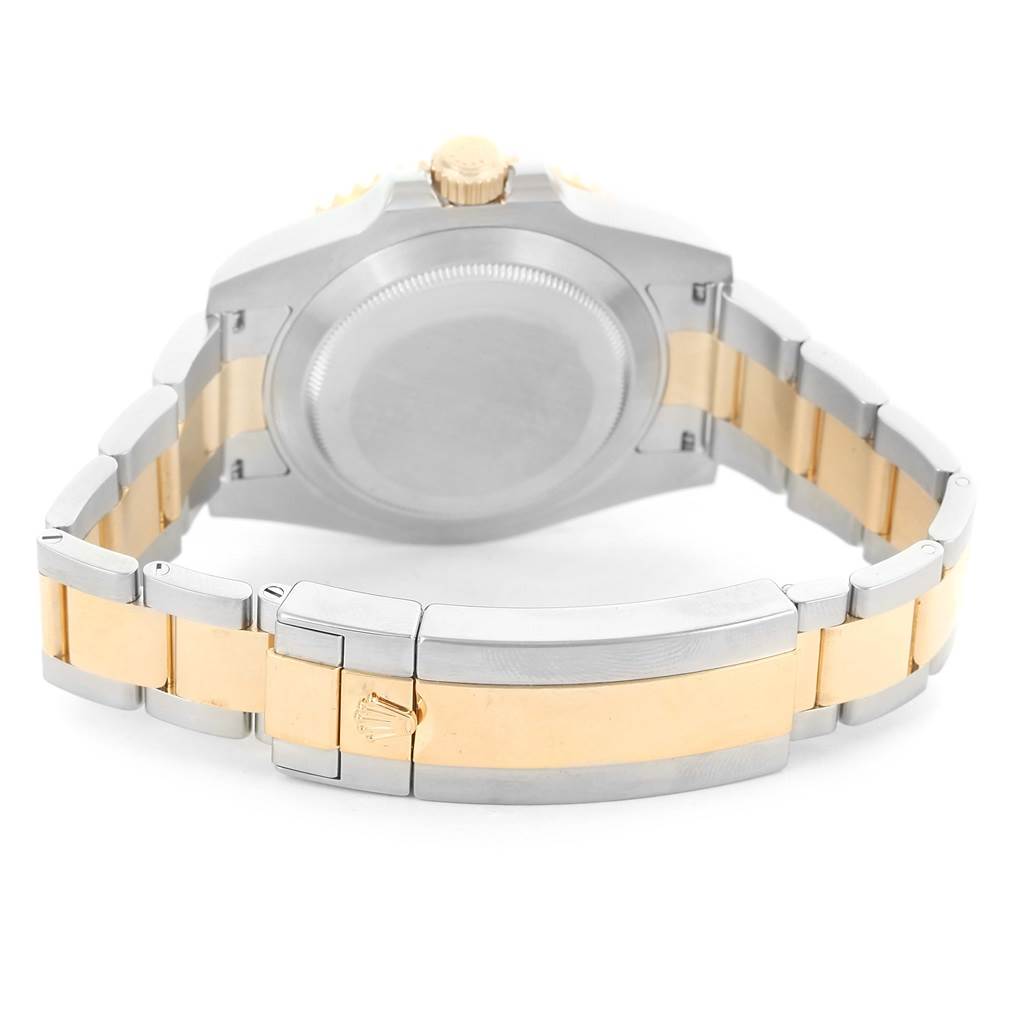 The image shows the back case and clasp of a Rolex Submariner 116613LN Men
s Steel and Gold (two tone) Black Dial 116613LN Men
s Steel and Gold (two tone) Black Dial watch at an angle highlighting its two-tone bracelet.