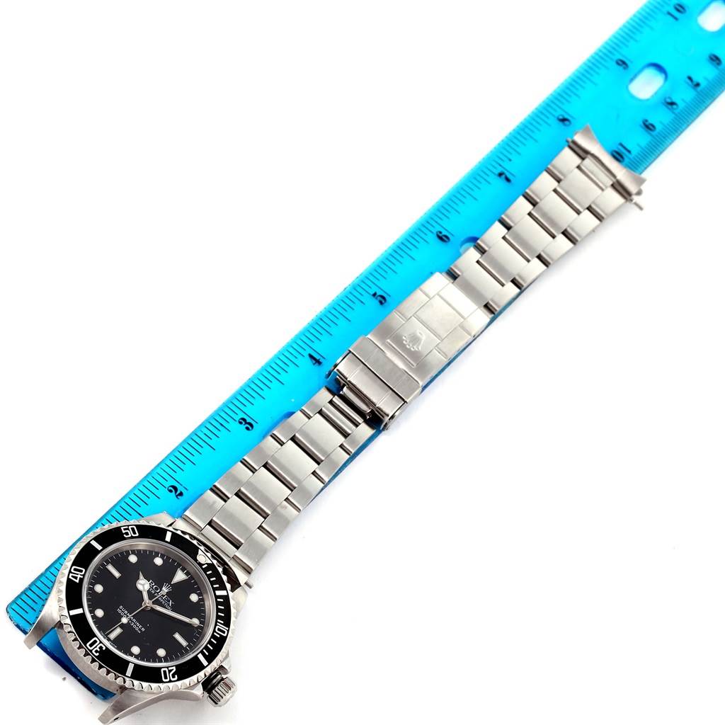 The image shows a top view of a Rolex Submariner 14060 Men
s Stainless Steel Black Dial 14060 Men
s Stainless Steel Black Dial watch, including the dial, bezel, bracelet, and clasp.