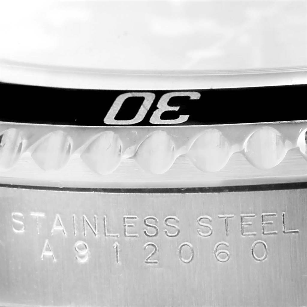The image shows a close-up of the bezel and part of the stainless steel case of a Rolex Submariner 14060 Men
s Stainless Steel Black Dial 14060 Men
s Stainless Steel Black Dial.