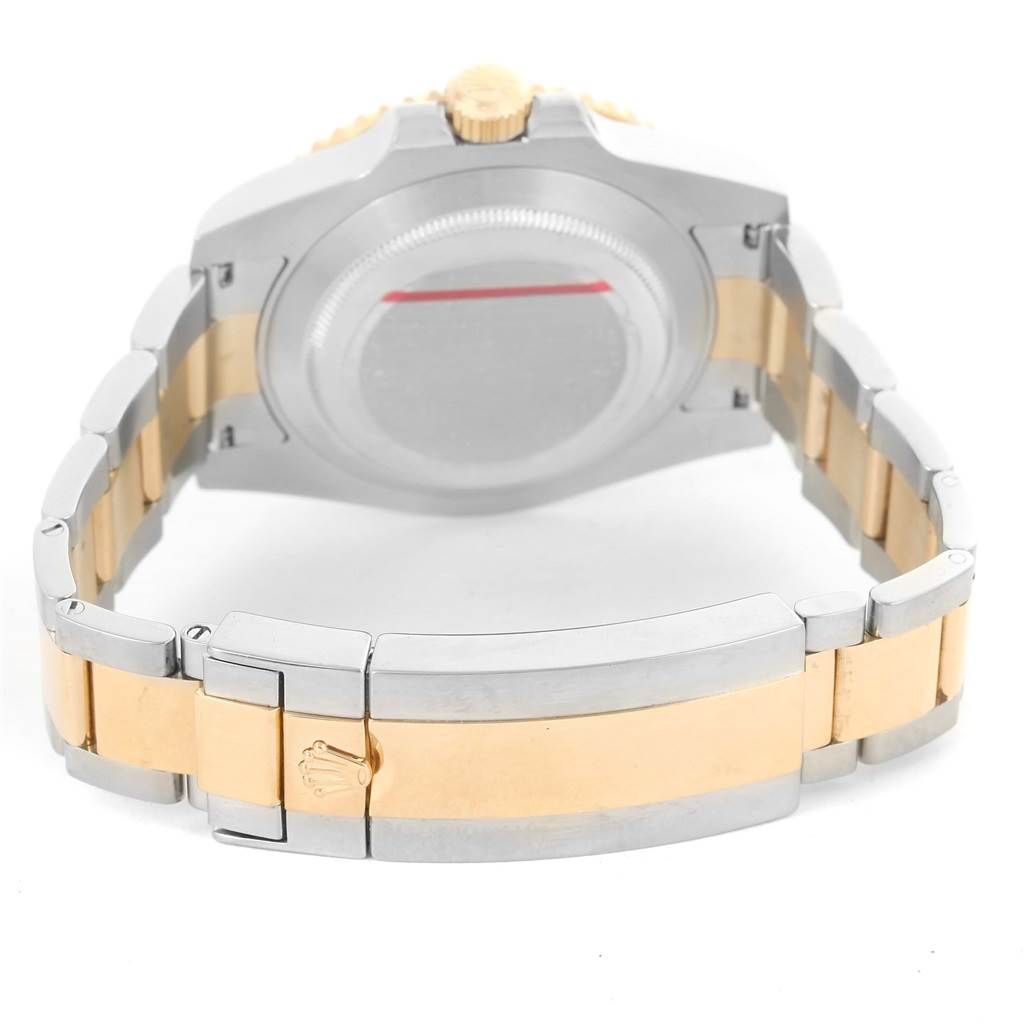 The image shows the back, clasp, and part of the bracelet of a Rolex Submariner 116613 Men
s Steel and Gold (two tone) Black Dial 116613 Men
s Steel and Gold (two tone) Black Dial watch from a rear angle.