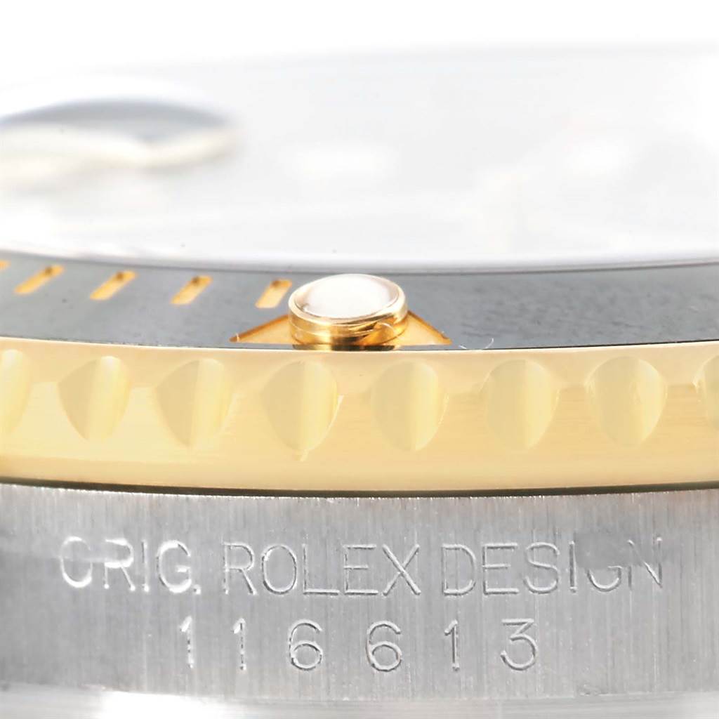 The image shows a close-up of the bezel and case edge of the Rolex Submariner 116613 Men
s Steel and Gold (two tone) Black Dial 116613 Men
s Steel and Gold (two tone) Black Dial model, including the engraved model number.