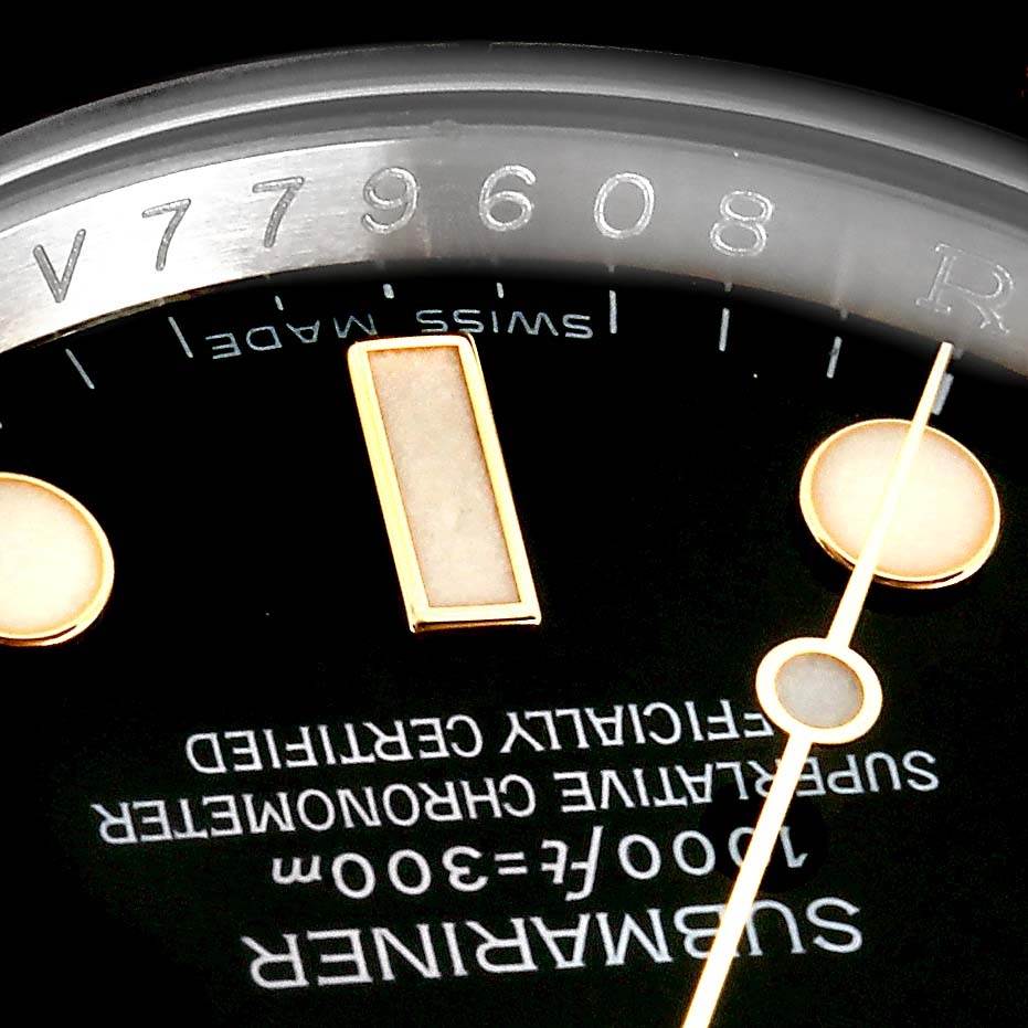 The image shows a close-up of the dial and rehaut of a Rolex Submariner 116613 Men
s Steel and Gold (two tone) Black Dial 116613 Men
s Steel and Gold (two tone) Black Dial, displaying the serial number and "SWISS MADE" marking.