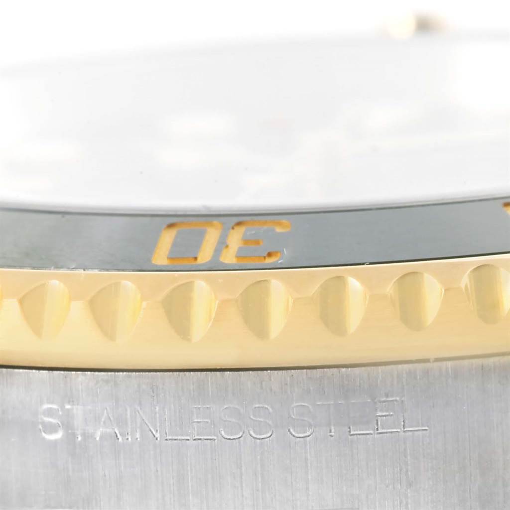 The close-up image shows the side view of the bezel and case of a Rolex Submariner 116613 Men
s Steel and Gold (two tone) Black Dial 116613 Men
s Steel and Gold (two tone) Black Dial.
