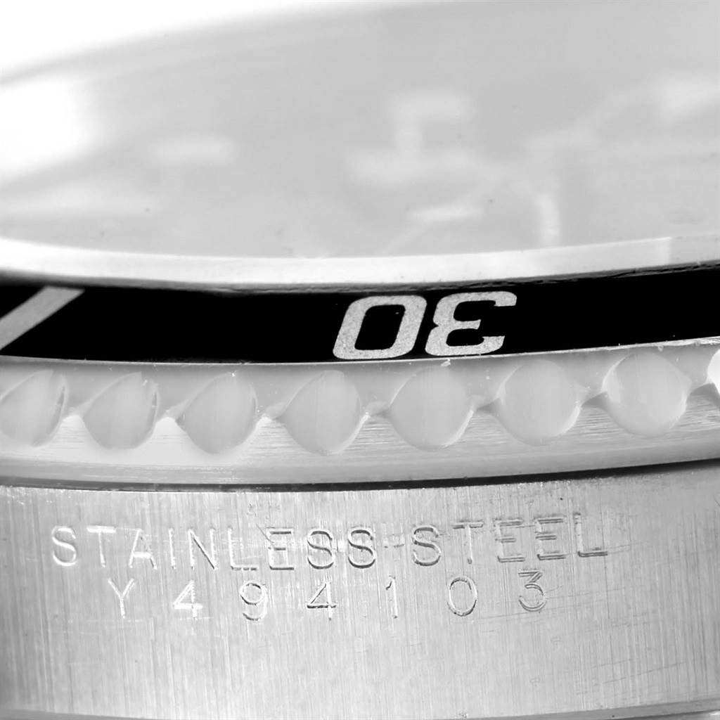 This image shows a close-up of the bezel and case markings from a Rolex Submariner 14060 Men's Stainless Steel Black Dial 14060 Men's Stainless Steel Black Dial watch, highlighting the "30" minute mark and "STAINLESS STEEL" engraving.