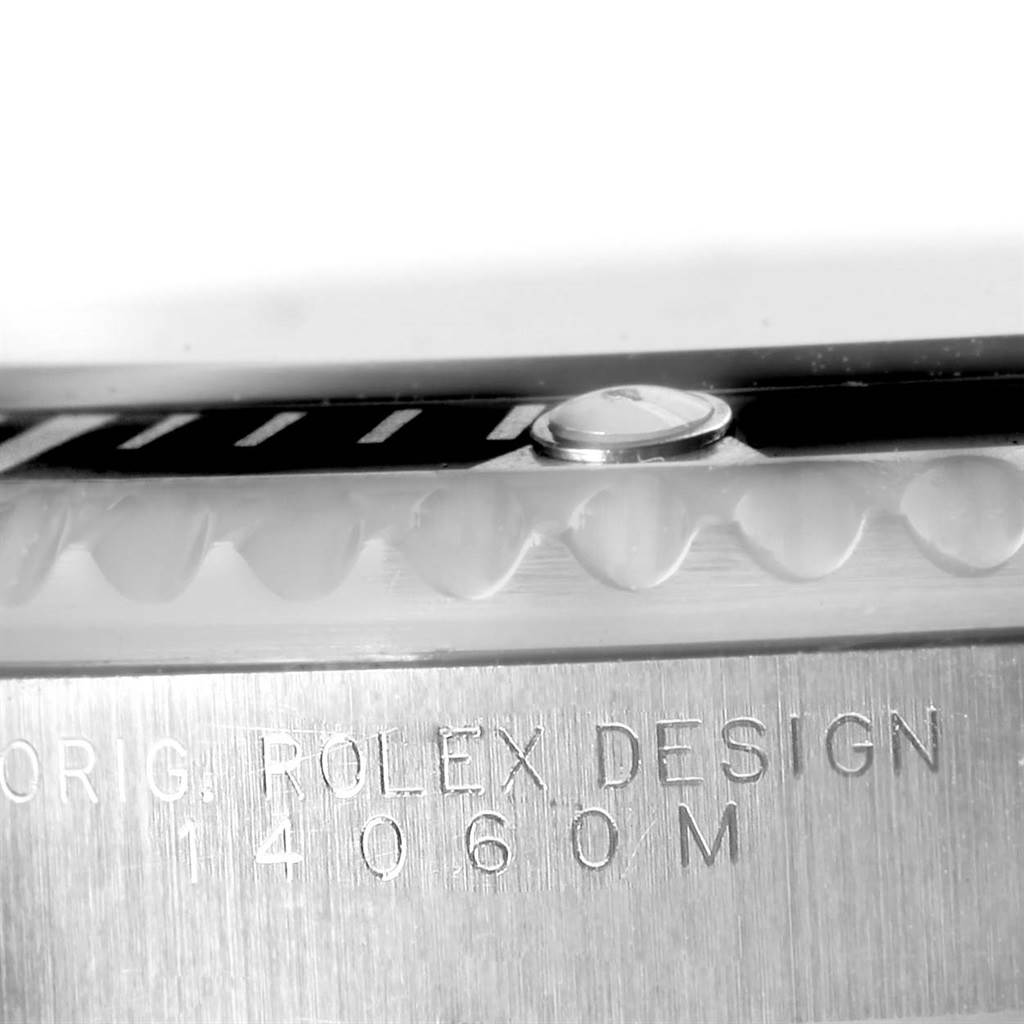 This is a close-up angle showing the bezel and the engraved case side of a Rolex Submariner 14060 Men's Stainless Steel Black Dial 14060 Men's Stainless Steel Black Dial watch.