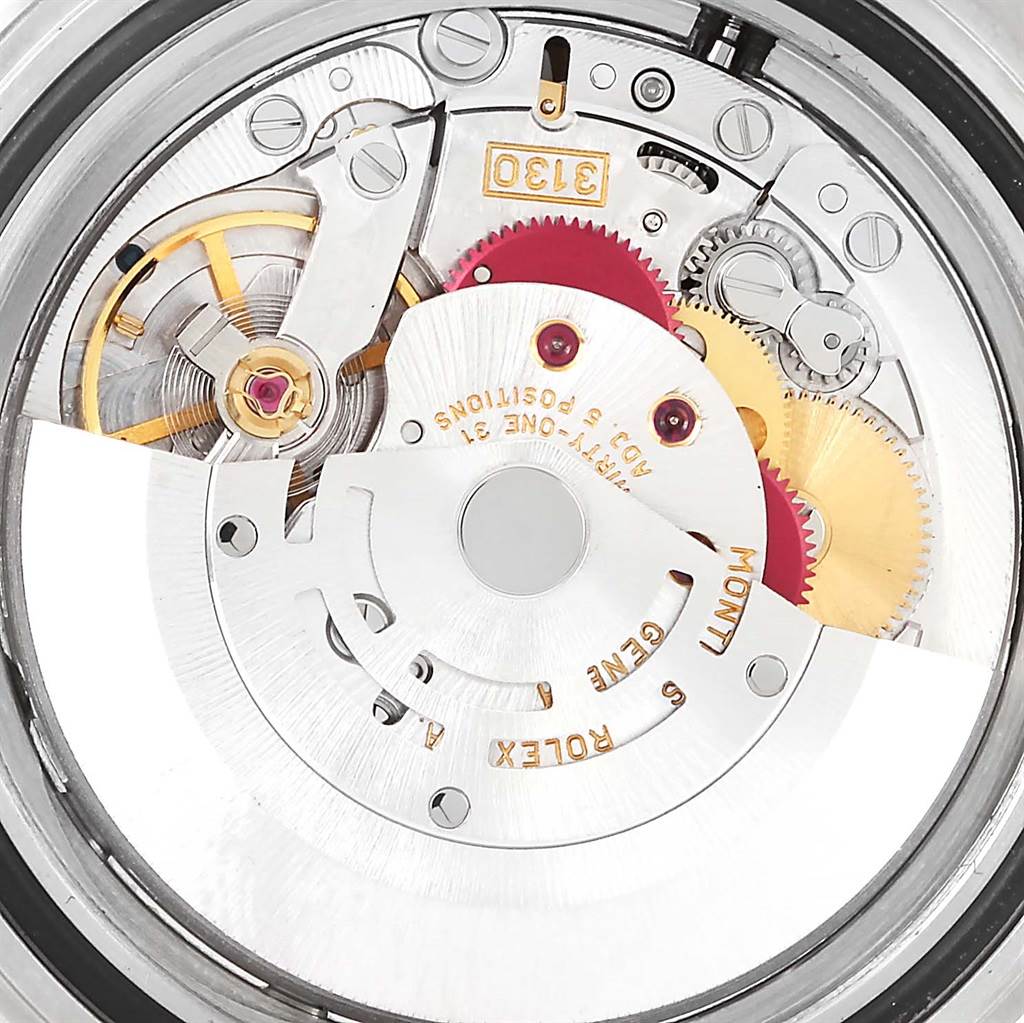 This image shows a close-up view of the internal mechanism of a Rolex Submariner 14060 Men's Stainless Steel Black Dial 14060 Men's Stainless Steel Black Dial watch, showcasing gears and components.