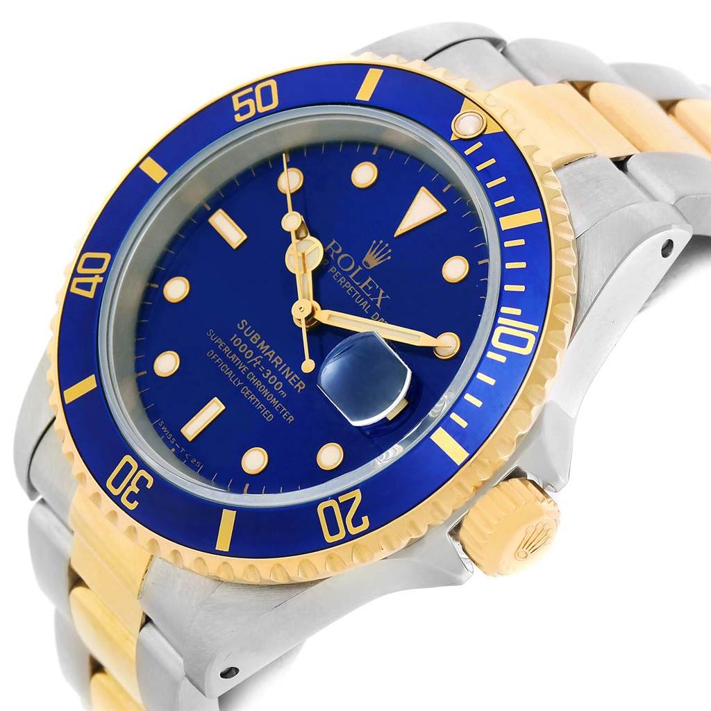 The image shows a close-up, angled view of a Rolex Submariner 16613 Men
s Steel and Gold (two tone) Blue Dial 16613 Men
s Steel and Gold (two tone) Blue Dial, focusing on the watch face, bezel, crown, and part of the two-tone bracelet.