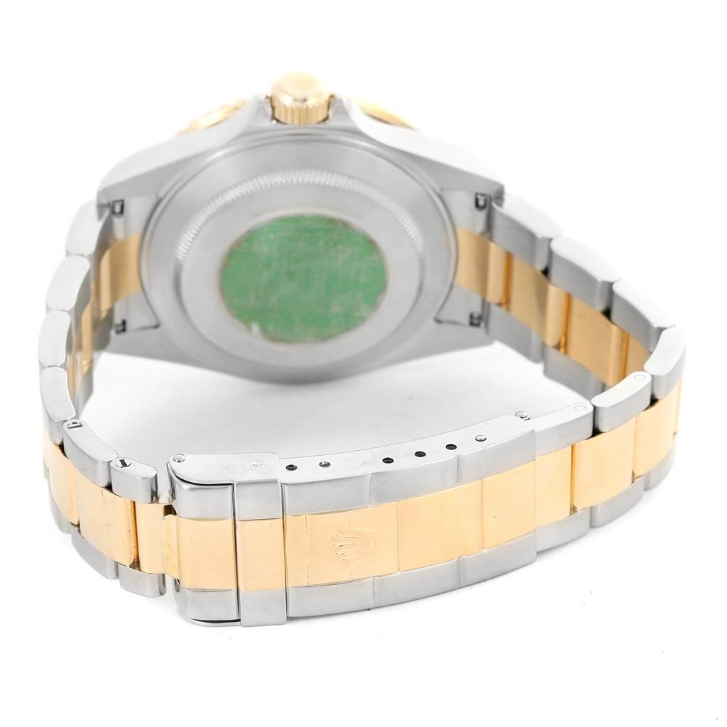 The image shows the back view of a Rolex Submariner 16613 Men
s Steel and Gold (two tone) Blue Dial 16613 Men
s Steel and Gold (two tone) Blue Dial watch, focusing on the case back and two-tone bracelet.