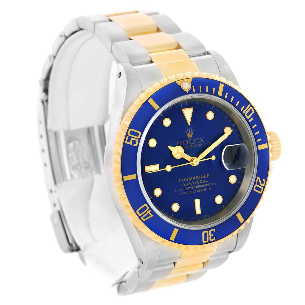 The Rolex Submariner 16613 Men
s Steel and Gold (two tone) Blue Dial 16613 Men
s Steel and Gold (two tone) Blue Dial watch is shown at an angle displaying the face, bezel, and part of its two-tone bracelet.