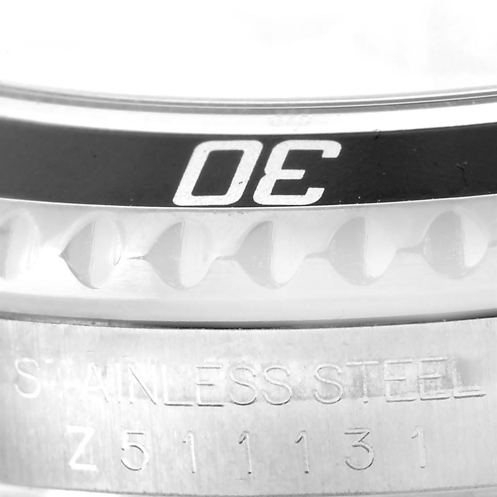 This close-up image shows the bezel and part of the stainless steel case with a serial number of a Rolex Submariner 16610 Men
s Stainless Steel Black Dial 16610 Men
s Stainless Steel Black Dial watch.