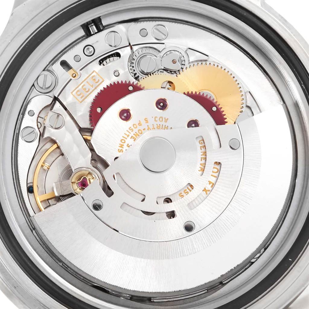 This image shows a close-up view of the movement mechanism of a Rolex Submariner 16610 Men
s Stainless Steel Black Dial 16610 Men
s Stainless Steel Black Dial watch, revealing its internal gears and components.