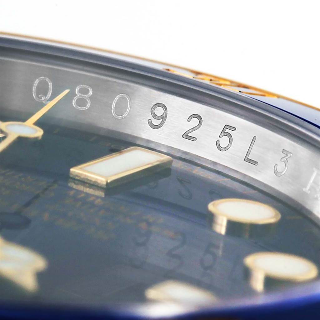 The image shows a close-up angle of the Rolex Submariner 116613 Men
s Steel and Gold (two tone) Blue Dial 116613 Men
s Steel and Gold (two tone) Blue Dial watch, highlighting its serial number engraving and part of the dial.