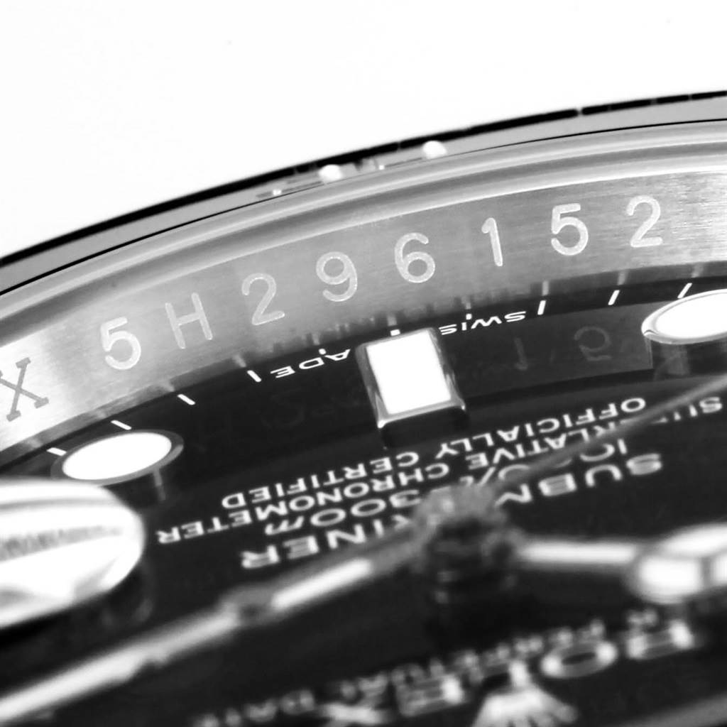 The image shows a close-up angle of the Rolex Submariner 116610 Men
s Stainless Steel Black Dial 116610 Men
s Stainless Steel Black Dial
s dial, bezel, and engraved serial number.