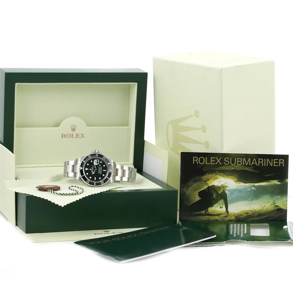 Displayed is the Rolex Submariner 16610 Men
s Stainless Steel Black Dial 16610 Men
s Stainless Steel Black Dial watch in its open box, along with manuals and accessories.