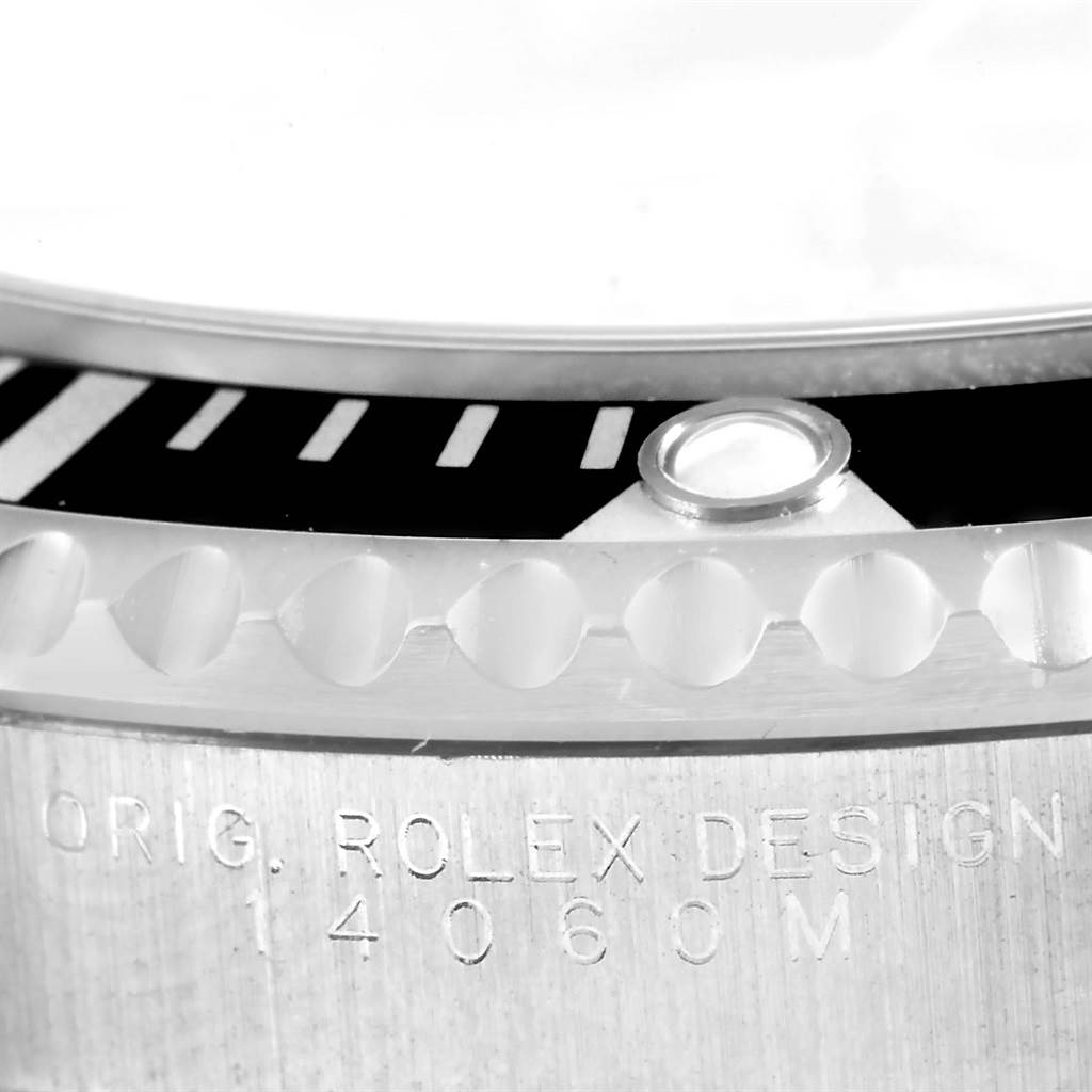 The image shows a close-up of the bezel and engraved case side of a Rolex Submariner 14060 Men
s Stainless Steel Black Dial 14060 Men
s Stainless Steel Black Dial watch.