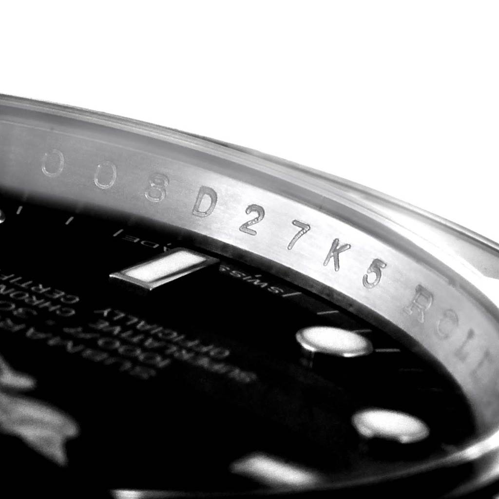 This is a close-up shot of the Rolex Submariner 14060 Men
s Stainless Steel Black Dial 14060 Men
s Stainless Steel Black Dial model, showing the rehaut with engraved serial numbers and parts of the dial.