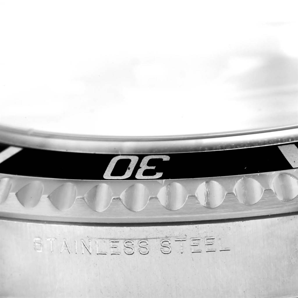 This close-up image shows the bezel and case of a Rolex Submariner 14060 Men
s Stainless Steel Black Dial 14060 Men
s Stainless Steel Black Dial, highlighting the "30" minute marker and "Stainless Steel" engraving.