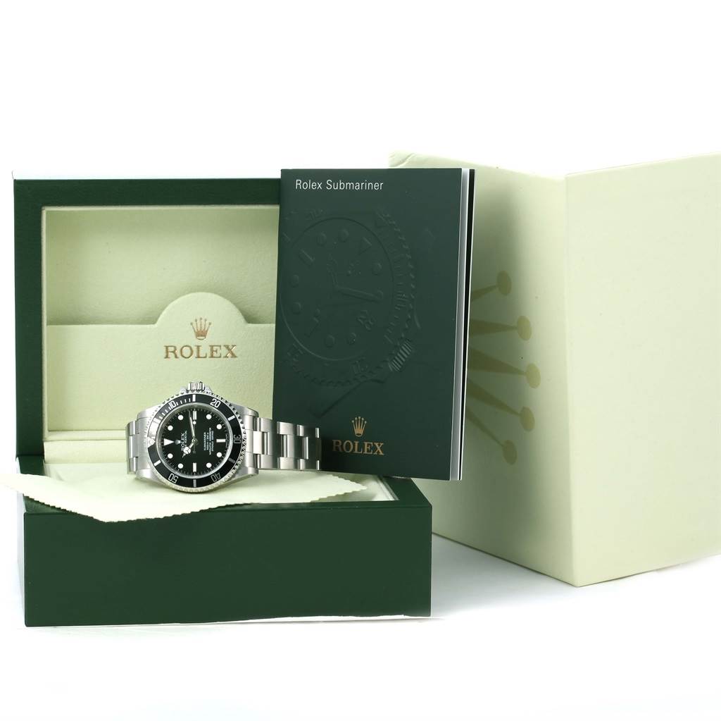 The Rolex Submariner 14060 Men
s Stainless Steel Black Dial 14060 Men
s Stainless Steel Black Dial watch is displayed in its box, with accompanying manuals and accessories visible from a front angle.