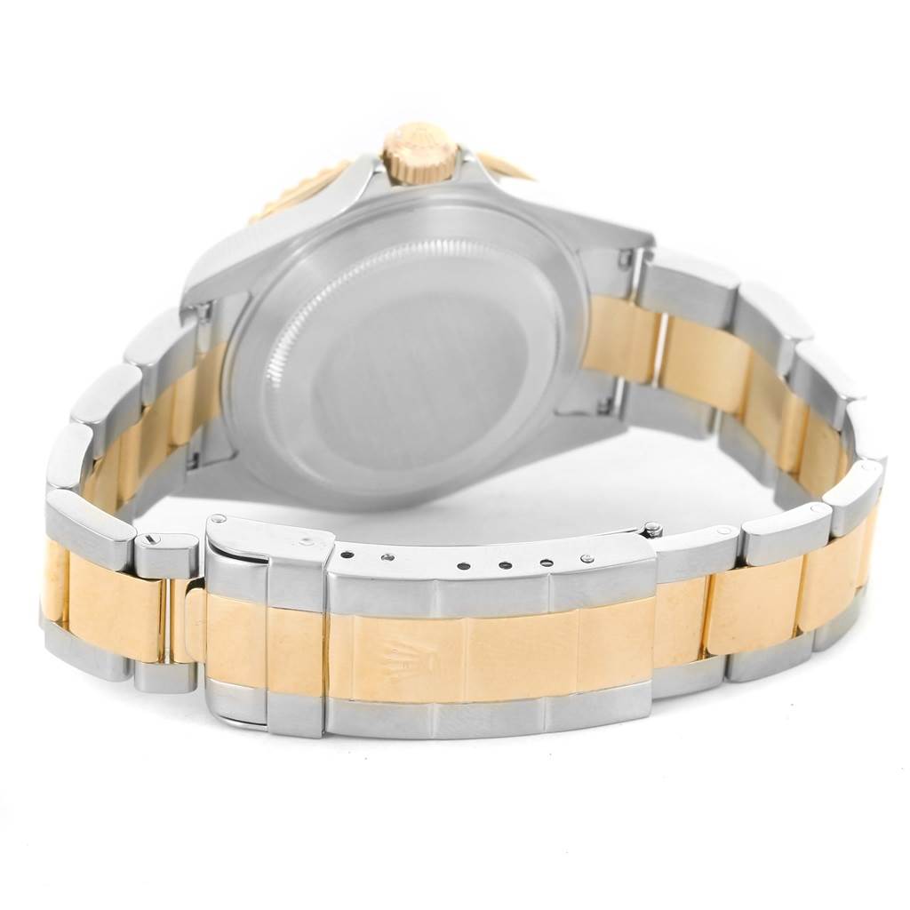 The image shows the back view of a Rolex Submariner 16613 Men
s Steel and Gold (two tone) Blue Dial 16613 Men
s Steel and Gold (two tone) Blue Dial watch, focusing on the case back and two-tone bracelet with the clasp.