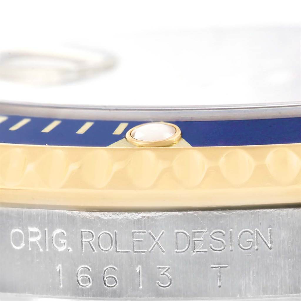 Close-up view of the Rolex Submariner 16613 Men
s Steel and Gold (two tone) Blue Dial 16613 Men
s Steel and Gold (two tone) Blue Dial bezel, showing the model number engraved on the watch case.