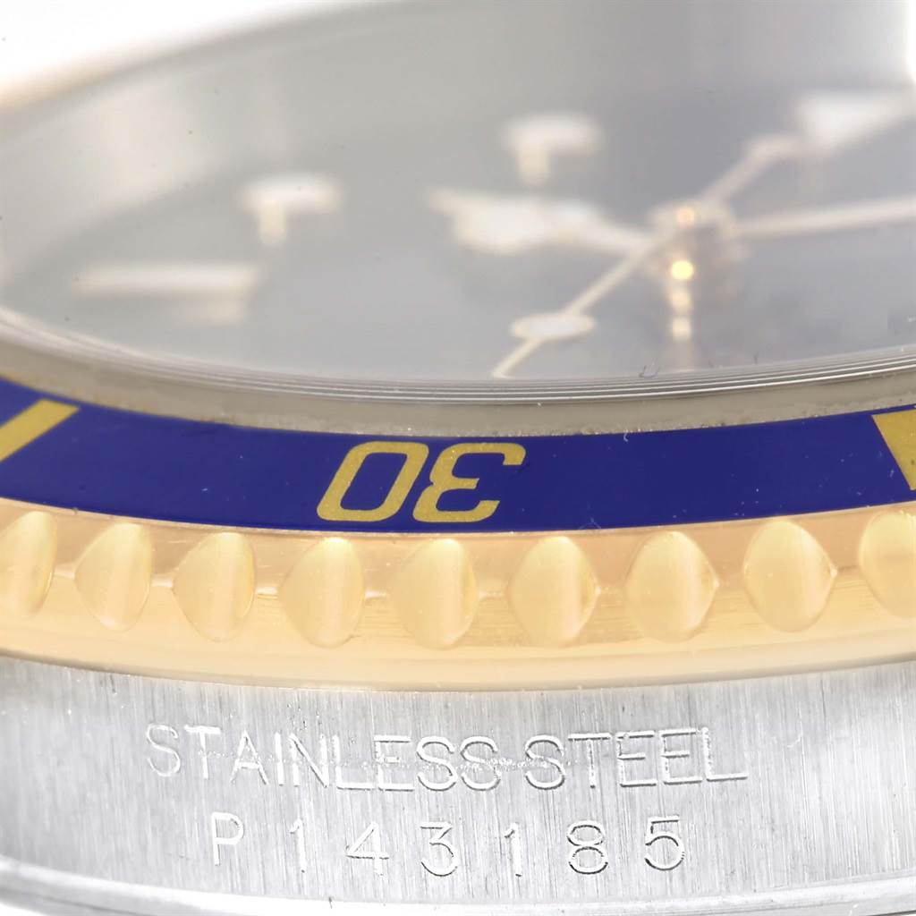 This close-up image features the bezel, the "30" minute marker, and the stainless steel case with serial number engraving of a Rolex Submariner 16613 Men's Steel and Gold (two tone) Blue Dial 16613 Men's Steel and Gold (two tone) Blue Dial watch.
