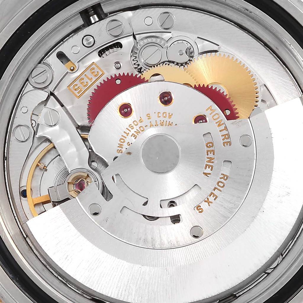The image shows the intricate internal mechanism of a Rolex Submariner 16613 Men's Steel and Gold (two tone) Blue Dial 16613 Men's Steel and Gold (two tone) Blue Dial watch from a close-up, side angle.