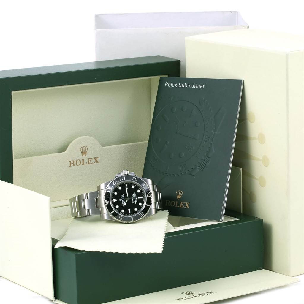 The image shows a Rolex Submariner 114060 Men
s Stainless Steel Black Dial 114060 Men
s Stainless Steel Black Dial watch, its box, and accompanying booklet from a slightly elevated front view.
