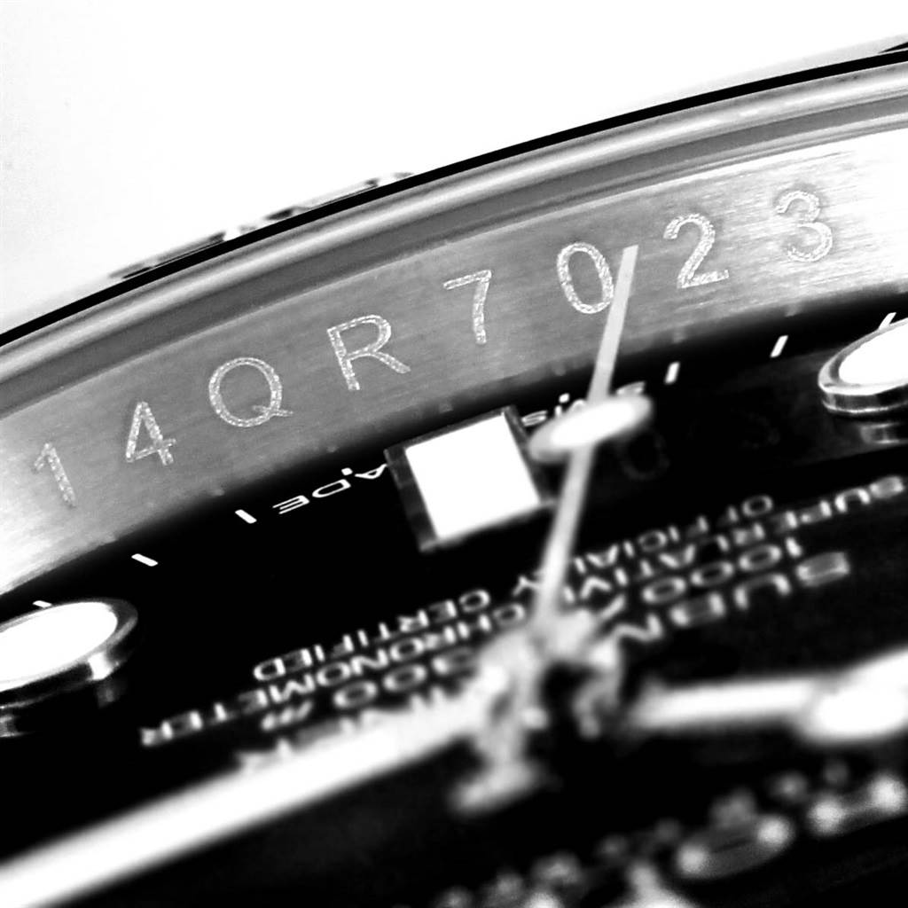 The image shows a close-up angle of the edge and part of the dial of a Rolex Submariner 114060 Men
s Stainless Steel Black Dial 114060 Men
s Stainless Steel Black Dial watch, highlighting the serial number.