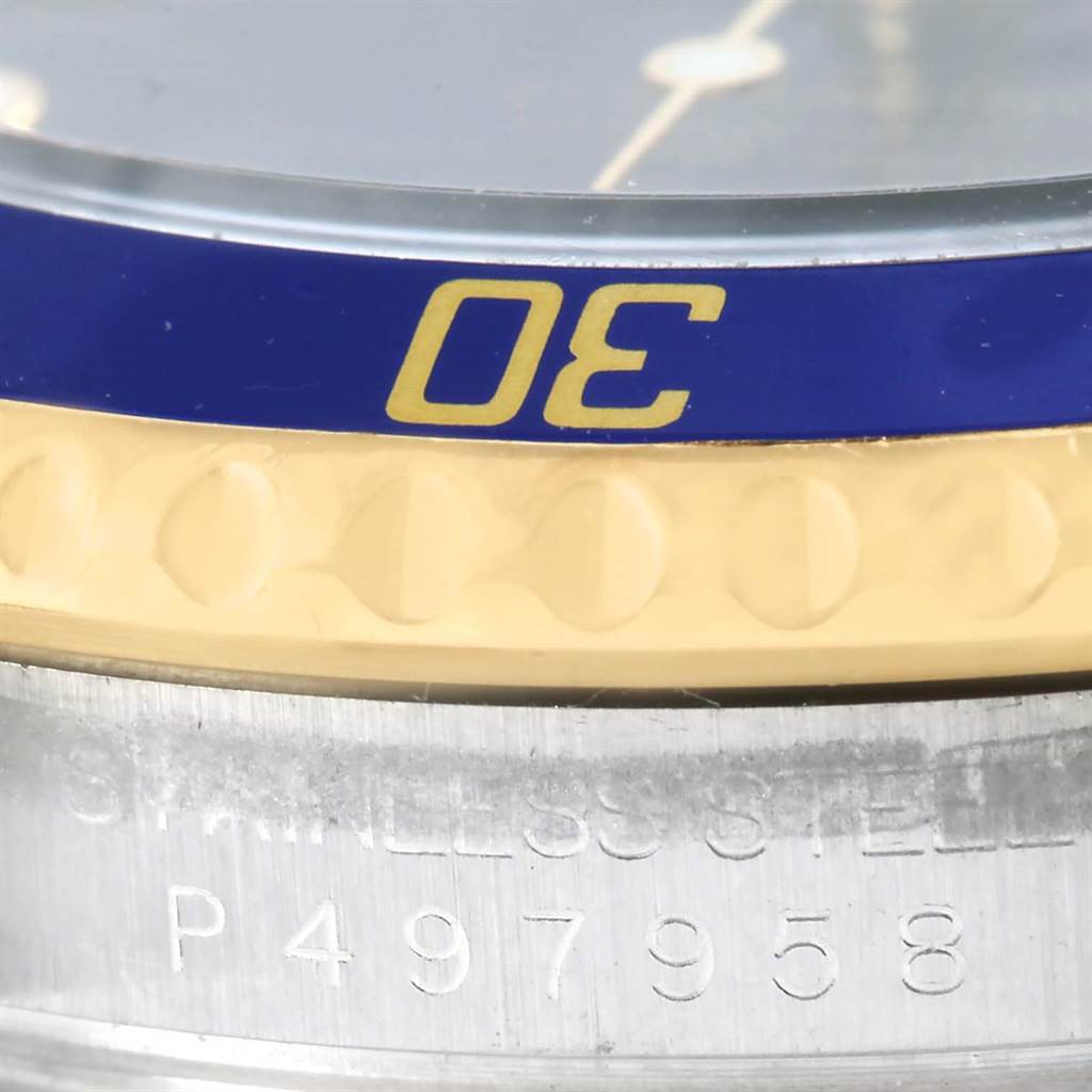 This close-up image shows the bezel and stainless steel case with serial number of a Rolex Submariner 16613 Men's Steel and Gold (two tone) Blue Dial 16613 Men's Steel and Gold (two tone) Blue Dial watch.