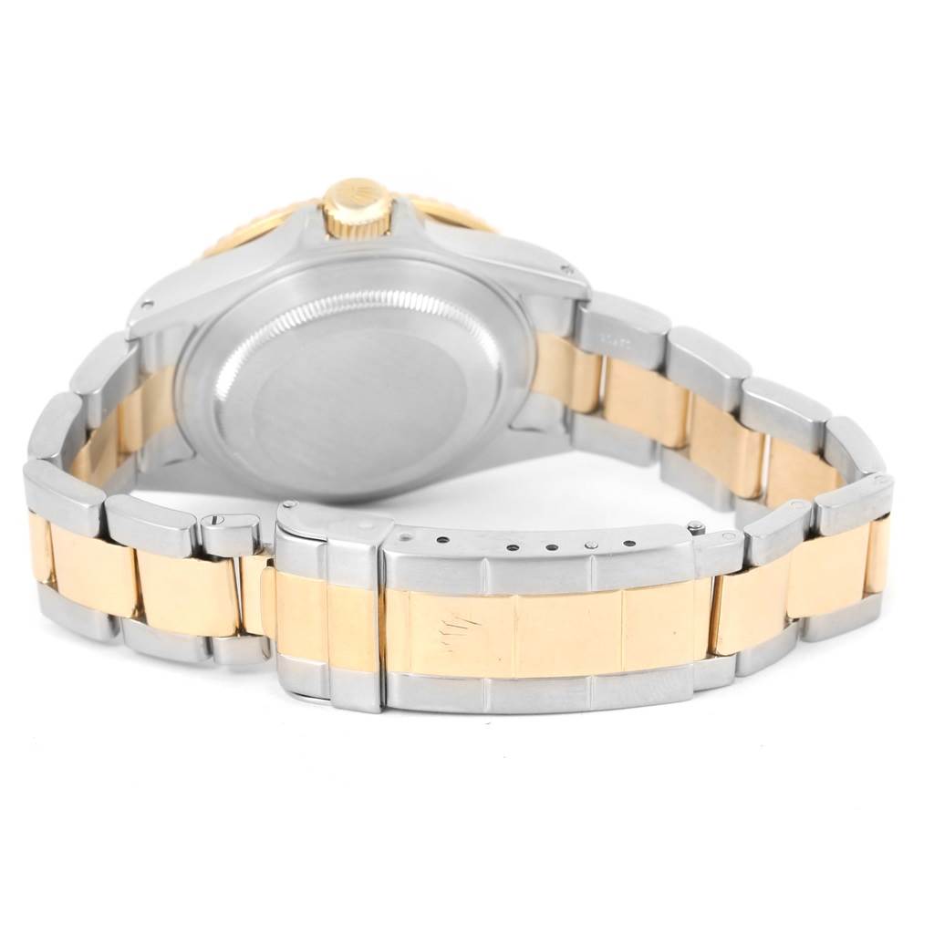 The image shows the rear angle of a Rolex Submariner 16613 Men's Steel and Gold (two tone) Blue Dial 16613 Men's Steel and Gold (two tone) Blue Dial watch, featuring the back case and two-tone bracelet clasp.