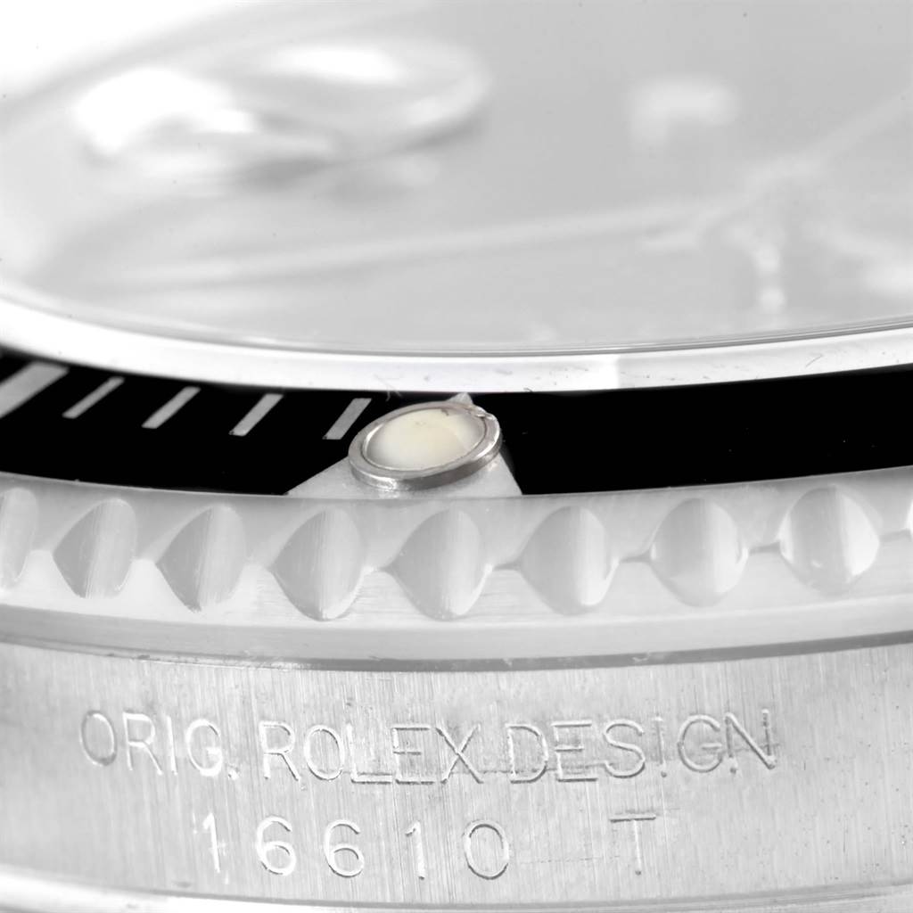 The image shows a close-up of the bezel and engraved serial number on a Rolex Submariner 16610 Men
s Stainless Steel Black Dial 16610 Men
s Stainless Steel Black Dial 16610.