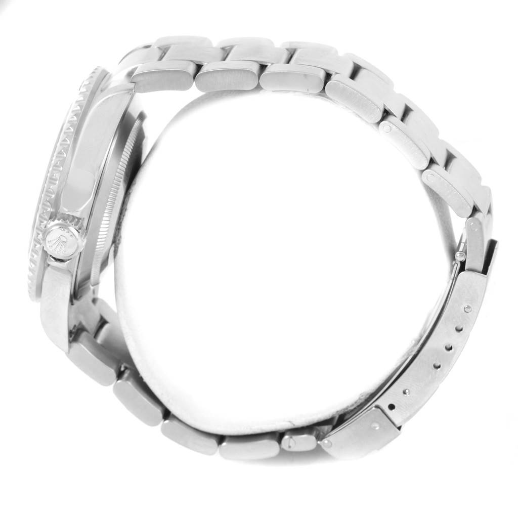 The image shows a side view of a Rolex Submariner 16610 Men
s Stainless Steel Black Dial 16610 Men
s Stainless Steel Black Dial watch, focusing on its bracelet, clasp, and side case with the crown.