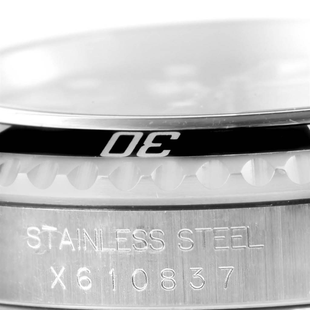 Close-up of the Rolex Submariner 14060 Men
s Stainless Steel Black Dial 14060 Men
s Stainless Steel Black Dial bezel and case, showing the "30" mark and stainless steel engraving.