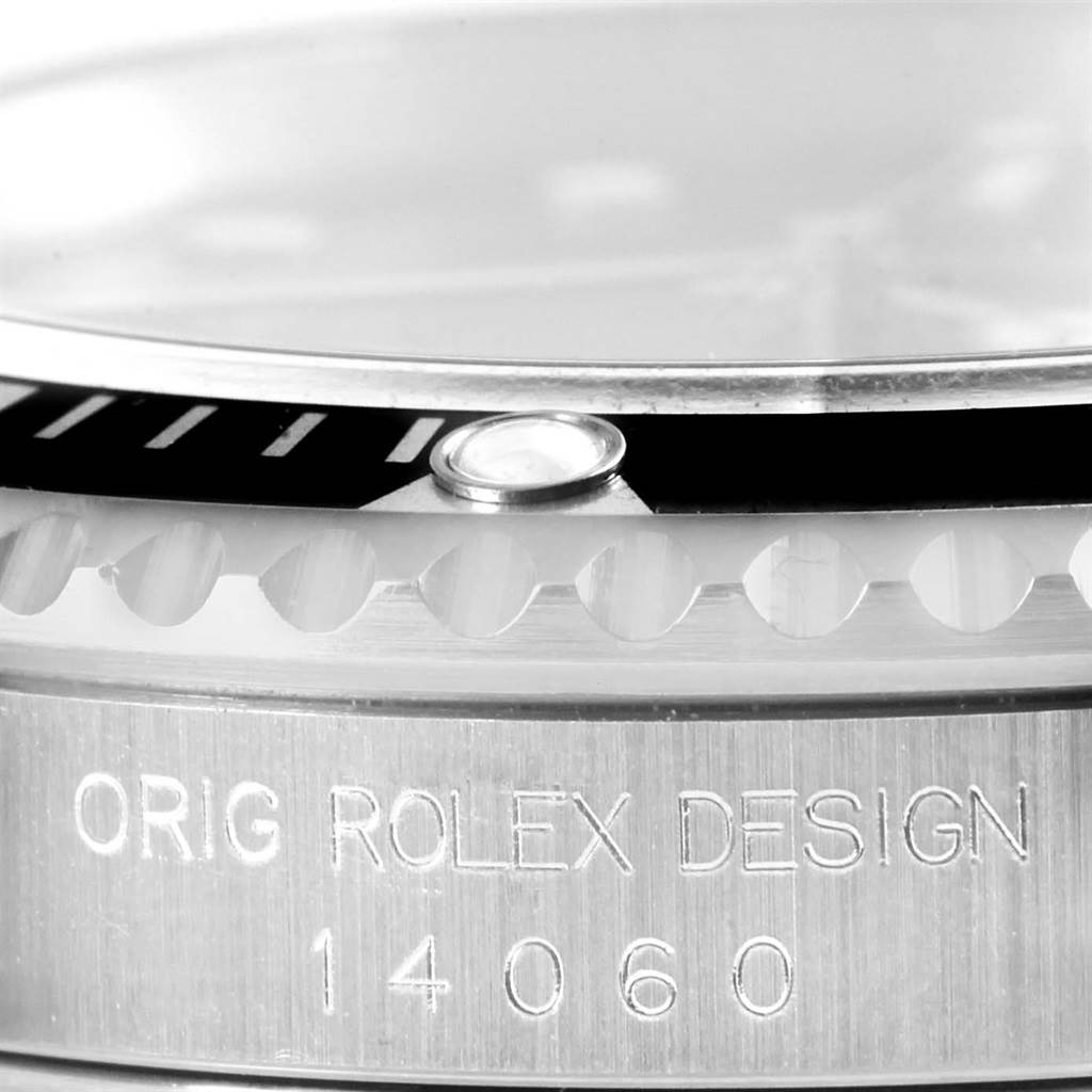 This close-up image of the Rolex Submariner 14060 Men
s Stainless Steel Black Dial 14060 Men
s Stainless Steel Black Dial shows the edge of the bezel and part of the case, engraving details visible.