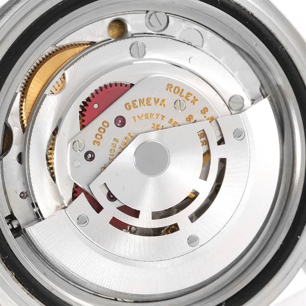 The image shows the intricate inner mechanism of a Rolex Submariner 14060 Men
s Stainless Steel Black Dial 14060 Men
s Stainless Steel Black Dial watch, focusing on the movement
s components.