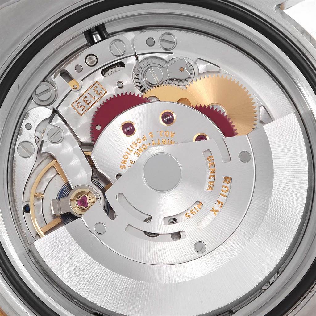 This image shows the intricate internal movement mechanism of a Rolex Submariner 116613 Men
s Steel and Gold (two tone) Blue Dial 116613 Men
s Steel and Gold (two tone) Blue Dial watch from a close-up angle.