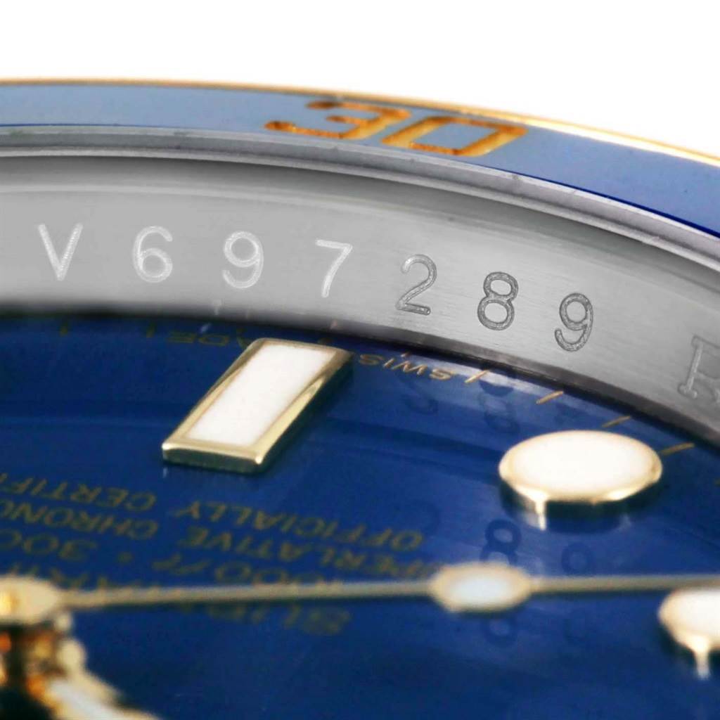 The image shows a close-up of the dial, bezel, and serial number of a Rolex Submariner 116613 Men
s Steel and Gold (two tone) Blue Dial 116613 Men
s Steel and Gold (two tone) Blue Dial watch.