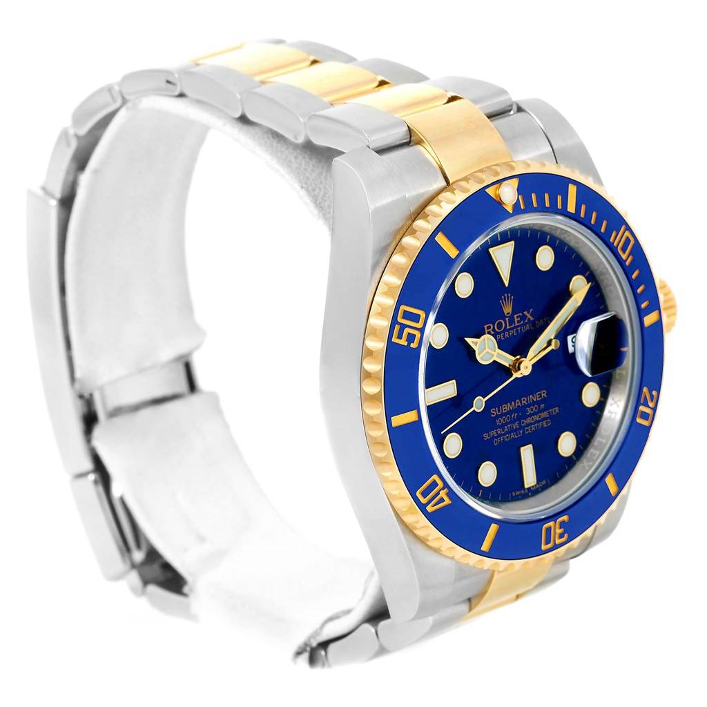 The image shows a Rolex Submariner 116613 Men
s Steel and Gold (two tone) Blue Dial 116613 Men
s Steel and Gold (two tone) Blue Dial watch at an oblique angle, highlighting its blue dial, blue bezel, and two-tone bracelet.