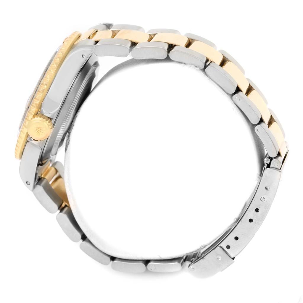 The image shows a side view of a Rolex Submariner 16613 Men's Steel and Gold (two tone) Black Dial 16613 Men's Steel and Gold (two tone) Black Dial, highlighting its gold and silver bracelet and crown.