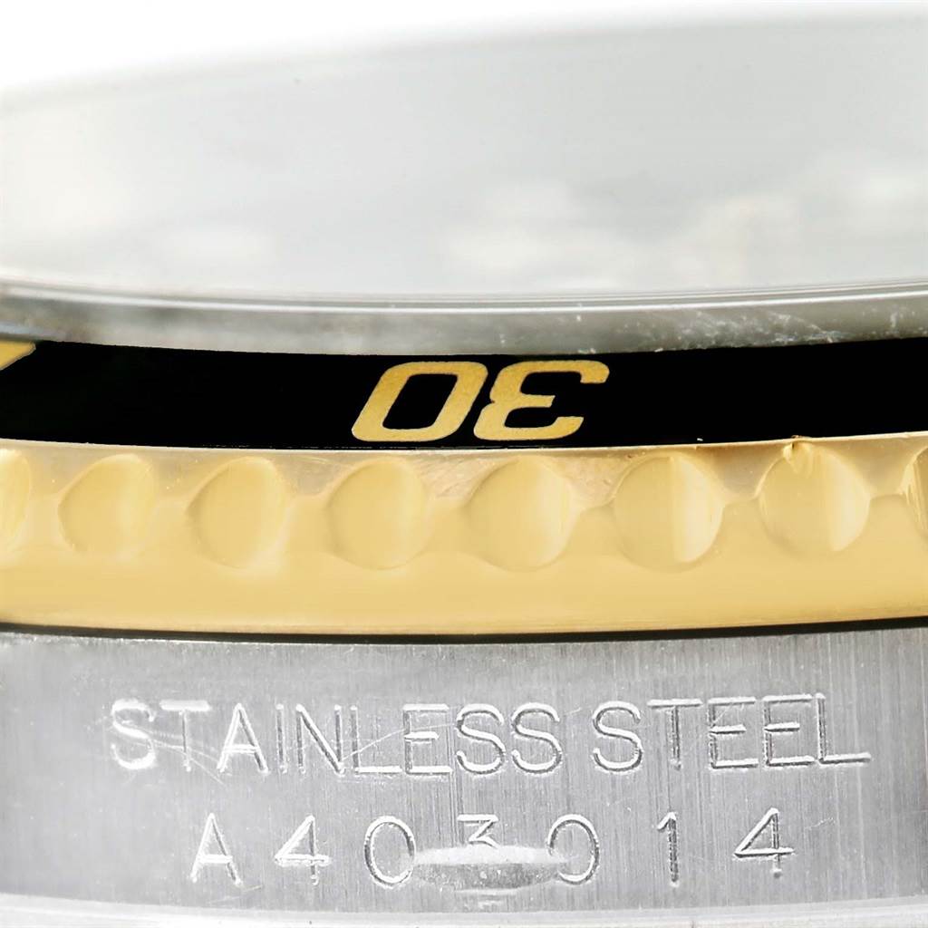 Close-up of the bezel and case side of a Rolex Submariner 16613 Men's Steel and Gold (two tone) Black Dial 16613 Men's Steel and Gold (two tone) Black Dial, showing the "30" marking and "STAINLESS STEEL" engraving.
