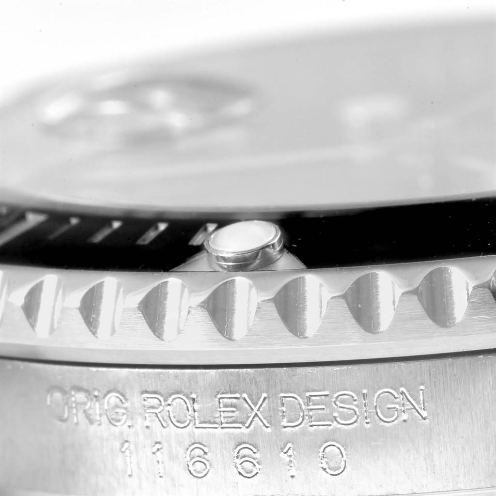 This close-up image shows the edge of the bezel and the inscription "ORIG. ROLEX DESIGN" with the model number 116610 on a Rolex Submariner 116610 Men's Stainless Steel Black Dial 116610 Men's Stainless Steel Black Dial.