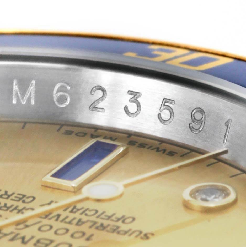 This image shows a close-up angle of the Rolex Submariner 16613 Men's Steel and Gold (two tone) Champagne Dial 16613 Men's Steel and Gold (two tone) Champagne Dial watch, focusing on its serial number and part of the dial.