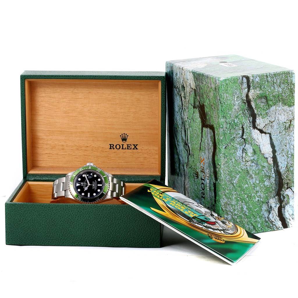 The image shows a Rolex Submariner 16610LV Men's Stainless Steel Black Dial 16610LV Men's Stainless Steel Black Dial watch in its box, with its packaging and a booklet, displaying a front view.