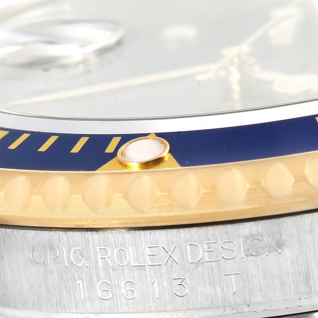 The image shows a close-up of the bezel and part of the case for the Rolex Submariner 16613 Men's Steel and Gold (two tone) Blue Dial 16613 Men's Steel and Gold (two tone) Blue Dial model 16613.