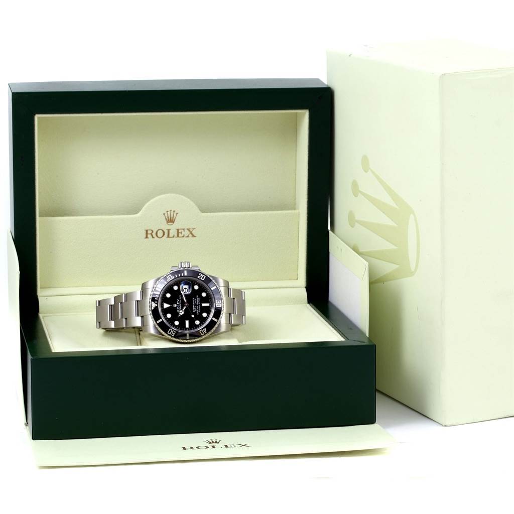 The Rolex Submariner 116610 Men's Stainless Steel Black Dial 116610 Men's Stainless Steel Black Dial watch is shown from the front, sitting in its green and cream-colored box.