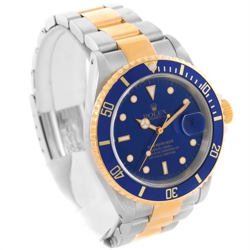 The image shows a Rolex Submariner 16613 Men's Steel and Gold (two tone) Blue Dial 16613 Men's Steel and Gold (two tone) Blue Dial watch from an angled view, highlighting the blue dial, bezel, and two-tone metal bracelet.