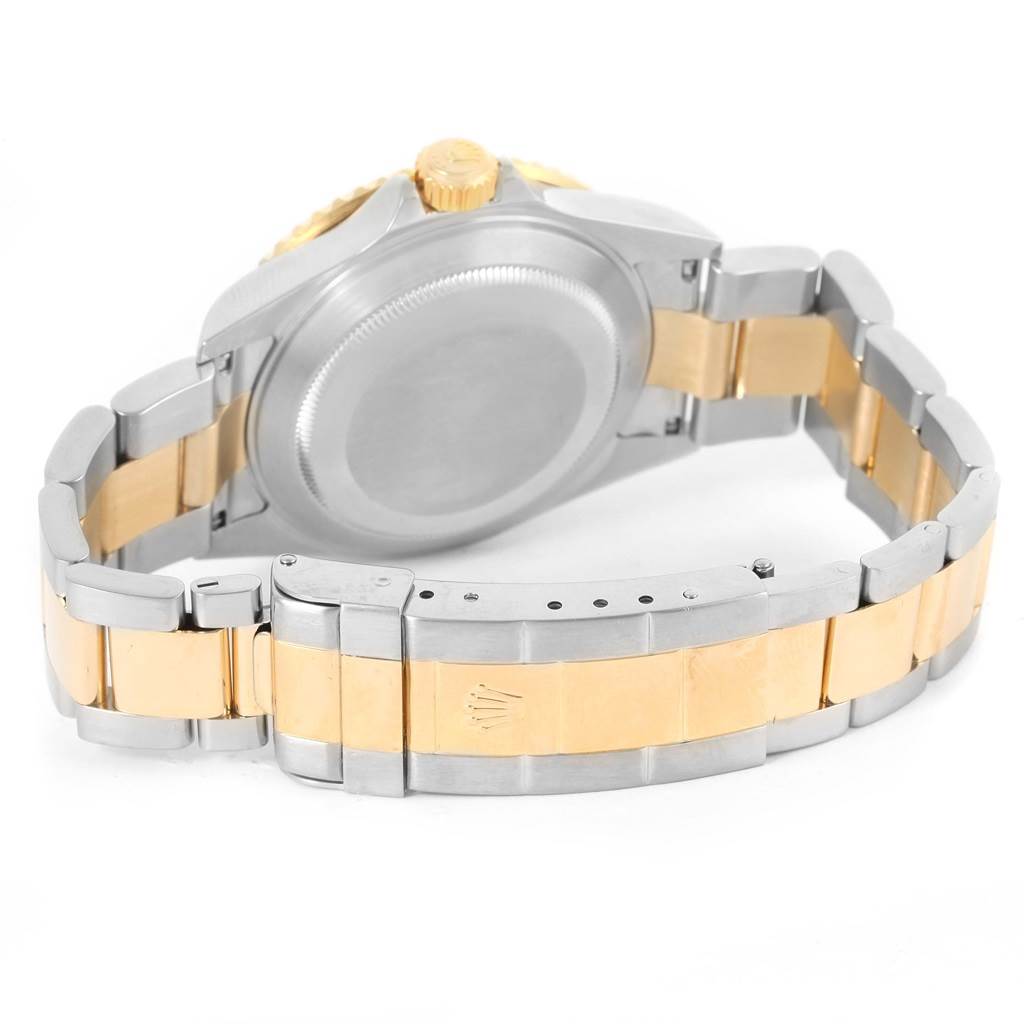 The image shows the back of a Rolex Submariner 16613 Men's Steel and Gold (two tone) Blue Dial 16613 Men's Steel and Gold (two tone) Blue Dial watch, highlighting its stainless steel and gold bracelet and clasp.